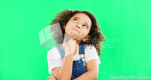 Image of Thinking, green screen and a child with a decision isolated on a studio background. Doubt, think and a confused girl kid looking thoughtful, contemplating and planning an idea with mockup space