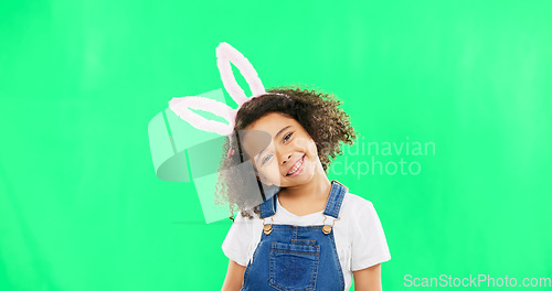 Image of Cute, happy and face of a child with bunny ears isolated on a green screen studio background. Easter, smile and portrait of an adorable little girl smiling, looking cheerful and playful with mockup