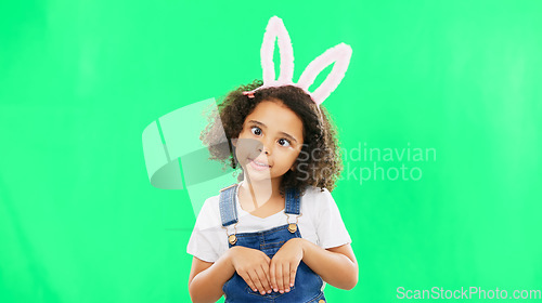 Image of Kids, easter and playful with a girl on a green screen background in studio feeling silly while having fun. Children, bunny and holiday with a cute little female child playing on chromakey mockup