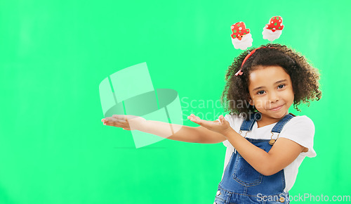 Image of Product placement, green screen and portrait of a child doing a presentation on a studio background. Branding, mockup and girl kid showing a space for marketing, display or advertising on a backdrop