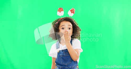 Image of Shock, face and child in a studio with green screen with a wtf, omg or surprise facial expression. Christmas, festive and portrait of a girl kid with a xmas headband and wow gesture by chroma key.