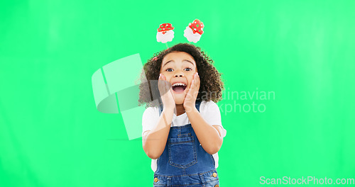 Image of Excited, happy face and child with green screen and smile and Christmas headband ready for celebration. Comic, surprised and shocked portrait of a young girl with happiness about holiday event