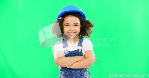 Image of Little girl, face and smile in construction on green screen with safety helmet and arms crossed against a studio background. Portrait of small and happy child architect smiling on chromakey mockup
