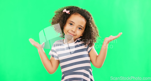 Image of Confused, question and child shoulder shrugging and unsure raise arms isolated in a studio green screen background. Portrait, girl and clueless young kid with doubt reaction or hand gesture