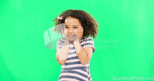 Image of Cute, happy and the face of a child on a green screen isolated on a studio background. Smile, laughing and portrait of an adorable little girl looking cheerful, playful and expressing happiness