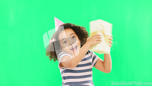 Image of Gift box, excited girl and green screen of a happy child with a birthday present in a studio. Celebration, youth and happiness of a kid shaking a package with a smile and energy from party gifts