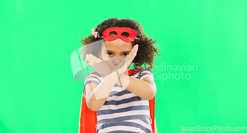 Image of Superhero, child and stop sign on green screen with hands to fight crime with fantasy or cosplay costume. Girl power, hero and pretend game with strong kid x portrait to protect freedom and justice