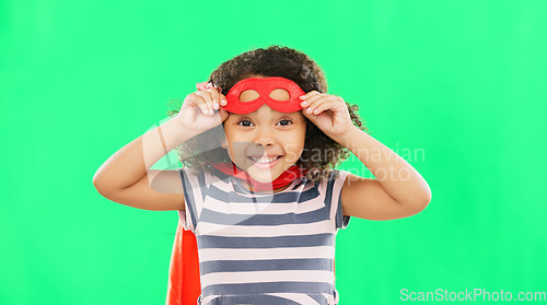 Image of Happy child, superhero and portrait on green screen with a smile to fight with fantasy, dream or cosplay costume. Girl power, hero and game with strong kid to protect freedom and justice with a mask