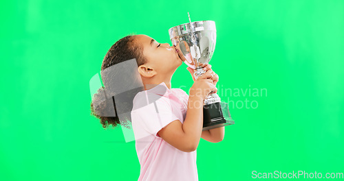 Image of Celebration, win and face of child with trophy isolated on a green screen studio background. Excited, success and portrait of a girl kissing an award for sports, achievement and champion with mockup