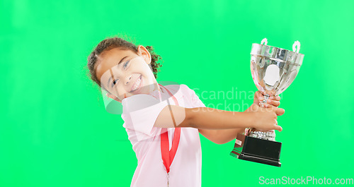 Image of Happy, winning and face of child with a trophy isolated on a green screen studio background. Excited, success and portrait of a girl kissing an award for sports, achievement and champion with mockup