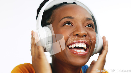 Image of Happy, black woman and headphones for streaming music, excited and celebration against a studio background. African American female, lady and headset with happiness, audio and girl singing with song