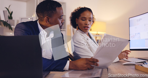 Image of Business, black man and woman with documents, night and discussion for project, planning and feedback. African American female employee, coworkers and staff with review, paperwork and data analysis