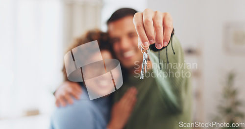 Image of Hand, keys and a home owner couple proud of their real estate property investment or purchase. House, mortgage or beginning with a blurred background man and woman together in their new apartment