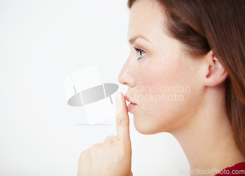 Image of Mockup, secret and woman with finger on lips in studio for gossip, drama or silent gesture on white background. Whisper, news and female with privacy, confidential or did you know, blackmail or emoji