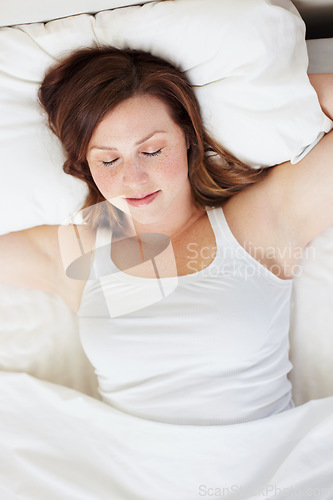 Image of Sleeping, rest and woman in bed from above, peaceful and enjoying a calm nap in her home. Top view, dreaming and female person in a bedroom for snooze, cozy and comfort on the weekend in a house