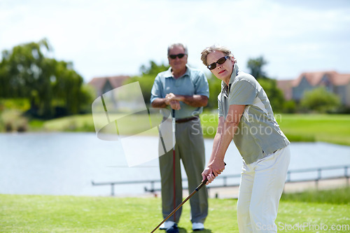 Image of Mature, woman or portrait of golfer on golf course for fitness, workout or stroke exercise in retirement. Senior couple, sunglasses or serious lady training in golfing sports game driving with a club