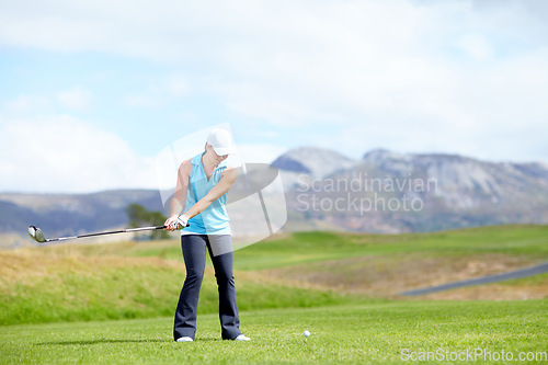 Image of Swing, woman or golfer playing golf for fitness, workout or exercise with a driver on a green course. Wellness, girl golfing or athlete training in action or sports game driving with a club stroke