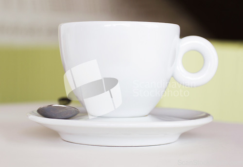 Image of Closeup, white cup and saucer in cafe, coffee shop and order for hot drinks beverage. Background, table crockery and teacup for drinking latte, cappuccino and espresso in restaurant or food industry