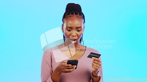 Image of Credit card fraud, phone scam or black woman with anxiety by fintech breach or financial theft. Password phishing, money stolen or banking privacy risk by online crime in studio on blue background