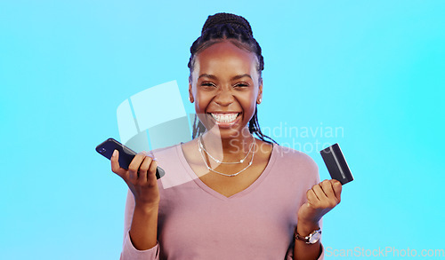 Image of Black woman, credit card and smartphone for online shopping, retail and payment with lady against a blue studio background. Nigerian female customer, client and shopper with cellphone and ecommerce