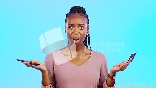 Image of Credit card fraud, phone scam or black woman shocked disappointed by fintech breach or financial theft. Password phishing, money stolen or banking privacy risk by online crime in studio on blue backg