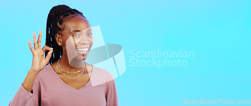 Image of Perfect, sign and woman with okay hand gesture smile and happy with mockup space isolated in a studio blue background. Portrait, satisfaction and African American woman with support and winning emoji
