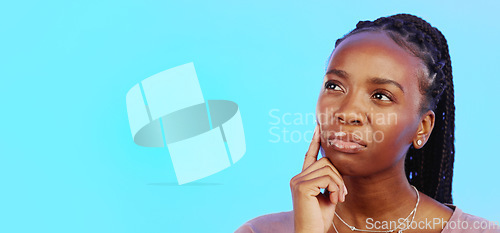 Image of Thinking, idea and black woman in doubt with mockup and confusion isolated on blue background. Ideas, concentration and difficult choice for African in studio space with thoughtful expression on face