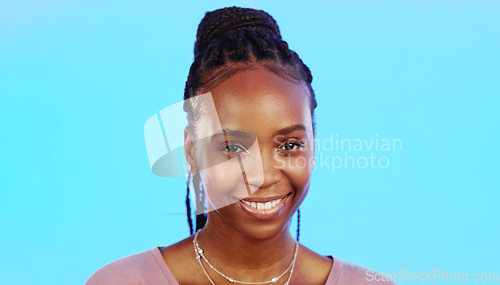 Image of Face, laughter and smile of an African girl in studio isolated on a blue background for fun or humor. Portrait, happy and laughing with an attractive young female enjoying a joke, comic or funny come