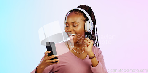 Image of Dance, music and headphones with black woman and phone in studio for freedom, streaming and online radio. Happiness, technology and relax with girl dancing to track, songs and audio on background
