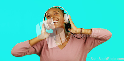 Image of Dance, music and headphones with black woman in studio for freedom, streaming and online radio. Happiness, technology and relax with girl dancing to track, songs and audio isolated on background