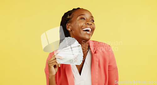 Image of Money, fan and winner with a black woman in studio on a yellow background holding cash, finance or wealth. Financial, investment and trading with dollar bills in the hand of a female after winning