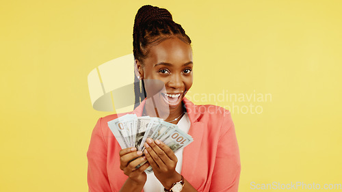 Image of Finance, fan and winner with a black woman in studio on a yellow background holding cash, money or wealth. Financial, investment and trading with dollar bills in the hand of a female after winning
