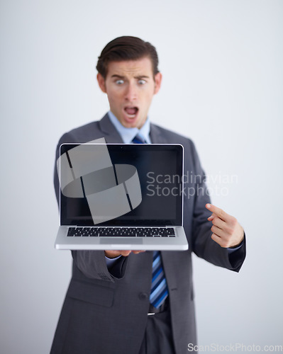 Image of Laptop screen, mockup and shocked with business man in studio for website, email and pointing. Wow, surprised and technology with employee in white background for corporate, internet and networking