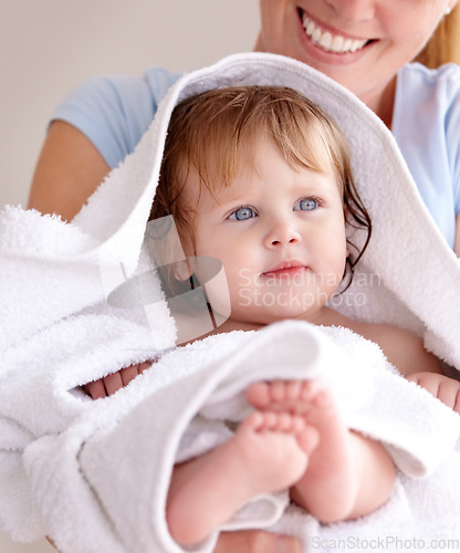 Image of Mom, hug and baby with bath for care or clean kid in a closeup at home with love for family life. Infant, towel and mother to hold with caring in arm for bond or cleaning or wellness of child.