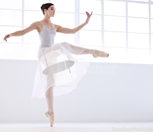 Image of Dance, ballet and moving with woman in studio for balance, elegant and performance. Artist, theatre and training with female ballerina dancing in class for competition, freedom and commitment