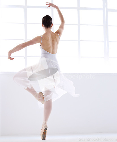 Image of Dance, ballet and creative with woman in studio for balance, elegant and performance. Artist, theatre and training with female ballerina dancing in class for competition, freedom and commitment