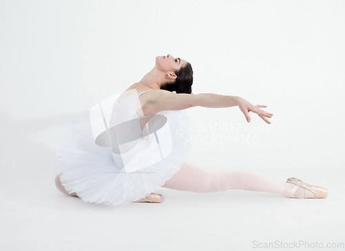 Image of Theatre, dance and ballet with a woman in studio on a white background for rehearsal or recital for a dancing performance. Art, creative and expression with a young ballerina or dancer in uniform