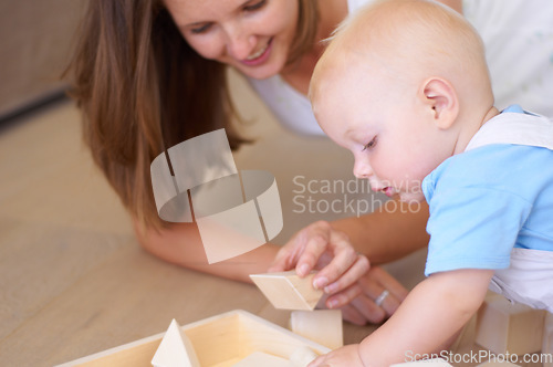 Image of Baby, mother with toy or wood building blocks for child development, help learning or knowledge. Mom, boy and teaching toddler to play with toys, learn and grow on floor of living room in home