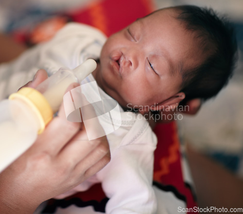 Image of Baby with cleft lip, milk and mother feeding from bottle for nutrition, health and wellness. Formula, newborn and hand of mom feed child for development, growth or healthy diet, food or lunch at home