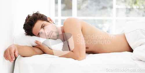 Image of Handsome portrait, man in bed and morning wake up time with sensual pose, relax and rest in apartment. Sleep, relaxing and sexy, tired topless male model with muscle waking in bright bedroom of home.