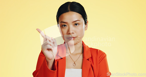 Image of Face, warning and Asian woman serious, finger and stop against a studio background. Portrait, Japanese female and lady with hand gesture for rejection, unhappy girl and frustrated with disagreement