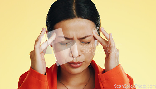 Image of Asian woman, headache and studio with stress, migraine and hands on head to massage temple by background. Young japanese model, pain and anxiety with mental health, fatigue and burnout by backdrop