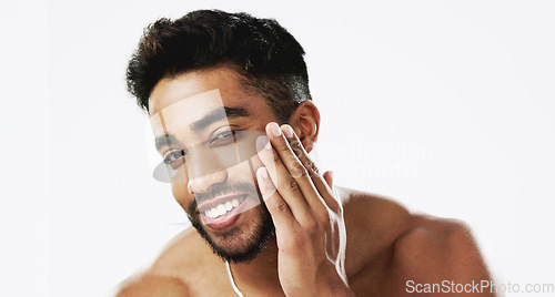 Image of Skincare, man and hands of face, happy and laughing against white background space. Touch, smile and portrait of Indian male model excited for wellness, beauty and cosmetic care result while isolated
