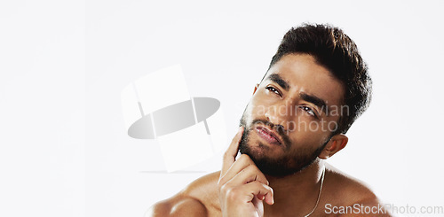 Image of Confused, thinking and face of man in studio for wellness, skincare and hygiene on white background. Doubt, portrait and indian male model with unsure emoji contemplating beauty cosmetic or body care