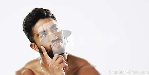 Image of Thinking, confused and face of man in studio for wellness, skincare and hygiene on white background. Doubt, portrait and indian male model with unsure emoji contemplating beauty cosmetic or body care