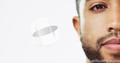 Image of Face, closeup and man in studio for skincare, against white background. Zoom and serious man portrait of Indian male model excited for wellness, beauty and cosmetic care while isolated