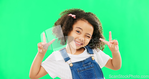 Image of Face, smile and child with peace sign on green screen in studio isolated on a background. Portrait, emoji and wink of happy kid or girl with v hand gesture or symbol for happiness or joy.