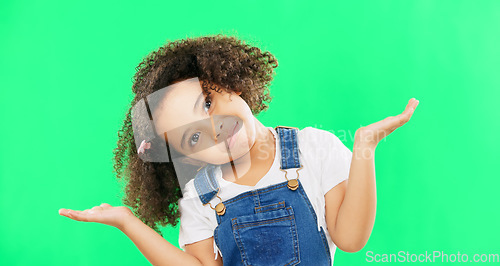 Image of Kids, doubt and a confused girl shrugging her shoulders on a green screen background in studio. Children, portrait and question with an adorable little female child asking on chromakey mockup