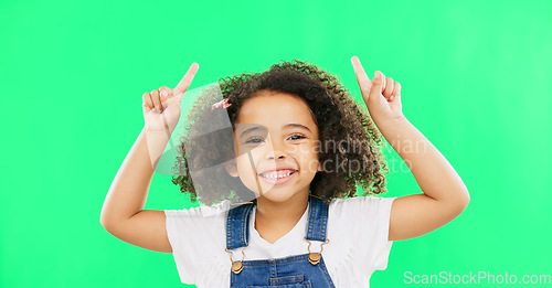 Image of Mockup, green screen and child pointing up at product placement space isolated against a studio background. Excited, happy and portrait of young kid advertising and marketing showing deal or sale