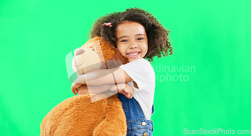 Image of Happy, little girl and hugging teddy bear on green screen of cute innocent child isolated against studio background. Portrait of adorable kid smile with soft toy hug for childhood on chromakey mockup